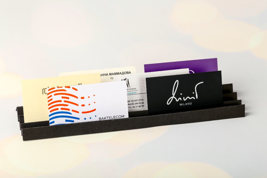 Baktelecom and Lini Milano business cards in holder — various print styles
