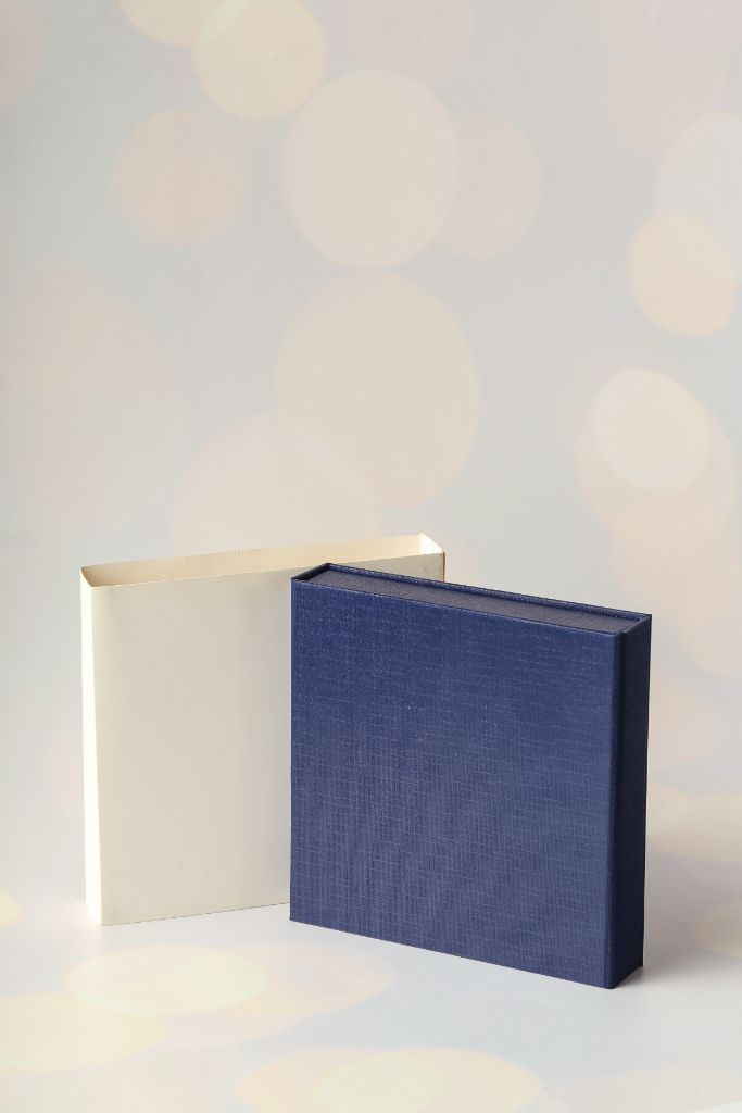 Pair of boxes — navy linen and cream with lid, square format