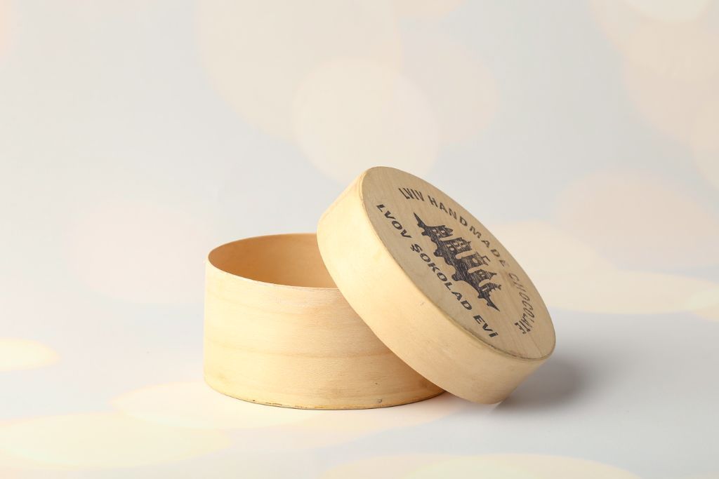 Round wooden box Lviv Handmade Chocolate — open, engraved lid, light wood