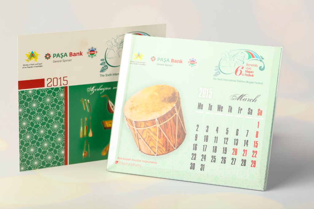 Desk calendar 2015 Muğam Festival — March page, photo of nagara (drum), PAŞA Bank and Ministry of Youth logos