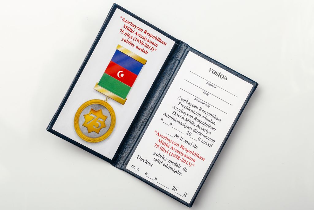Open ID booklet for the 75th Anniversary of Civil Aviation of Azerbaijan Medal — blue leather, medal with flag, text in Azerbaijani
