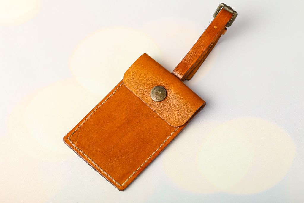 Reverse of leather luggage tag — card slot pocket, snap fastener
