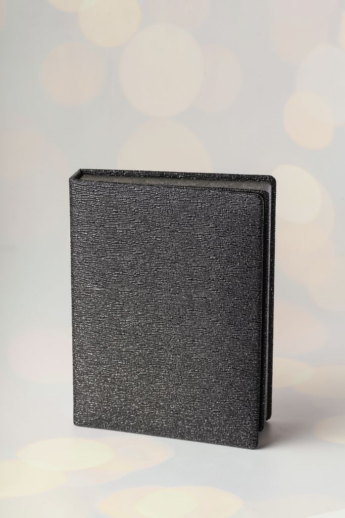 Leather notebook closed — black textured cover, handmade