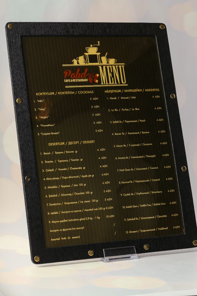 Pahd Cafe menu cover — black chalkboard with gold text and copper bolts
