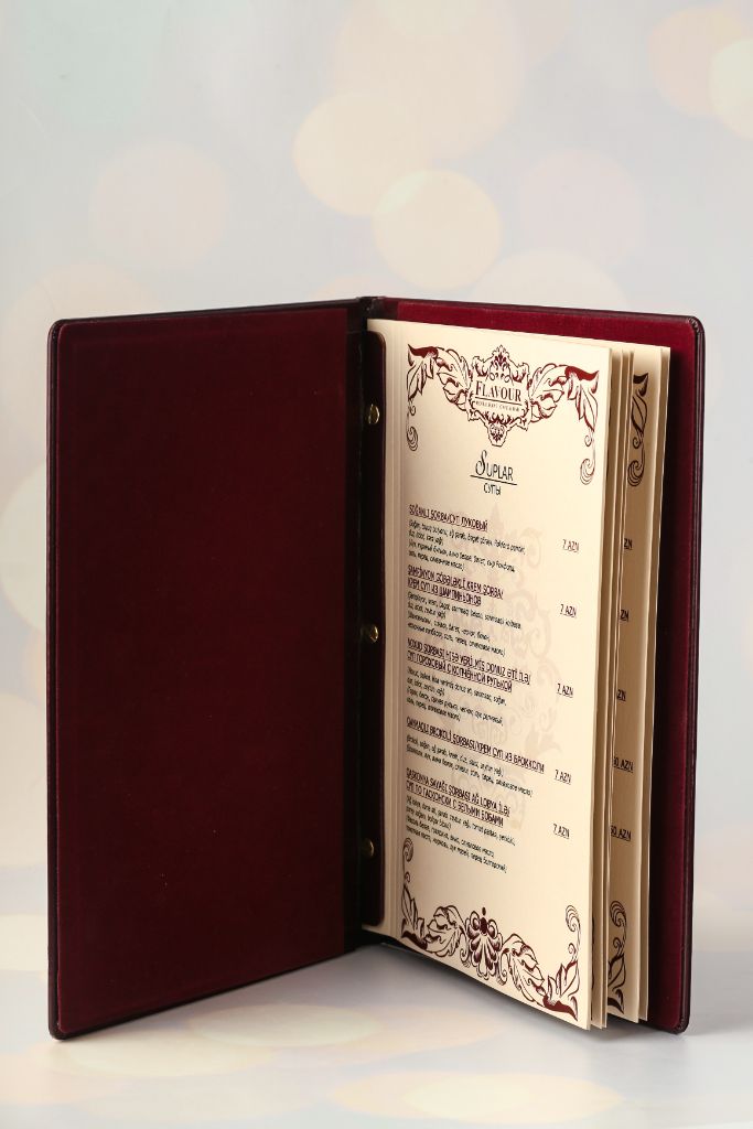 Flavour Restaurant menu open — leather ring-binder folder, Soups page