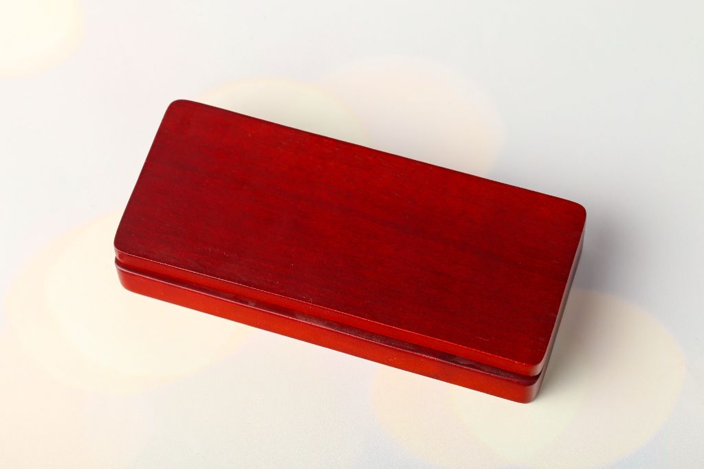 Wooden pen box closed — dark red wood, top view, rectangular