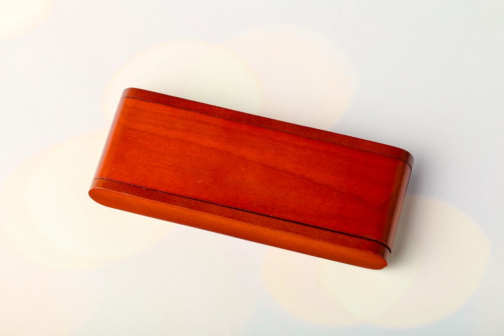 Wooden pen box closed — light cherry wood, horizontal, top view