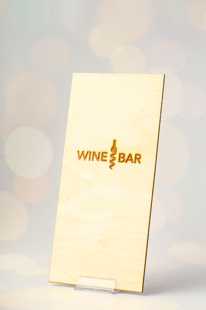 Wine Bar menu — wooden clipboard with engraved Wine Bar logo, front view