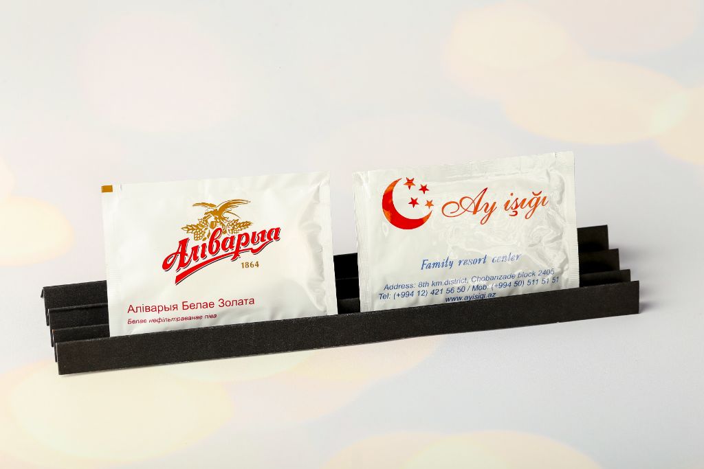 Branded napkins Alivaria 1864 and Ay İşığı Family Resort — logo, contact details, black holder