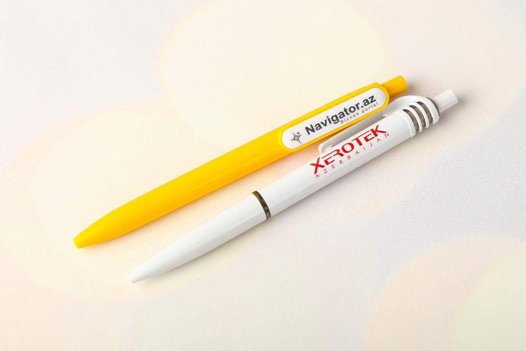 2 plastic click pens Navigator.az (yellow) and Xerotek Azerbaijan (white) — logo on barrel