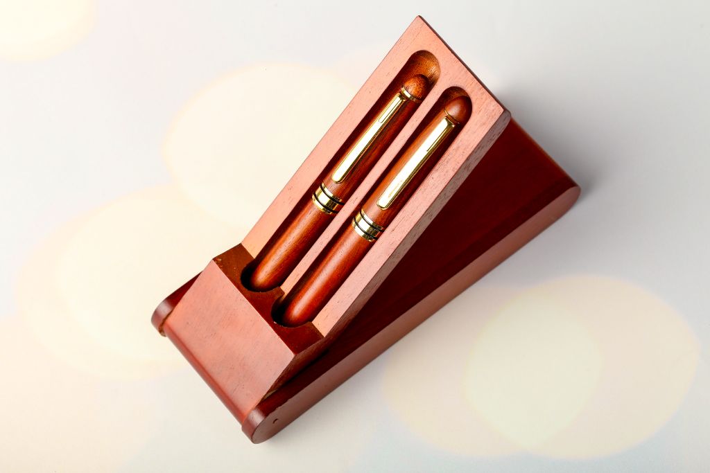 Wooden pen set — two rosewood pens with gold details in wooden box