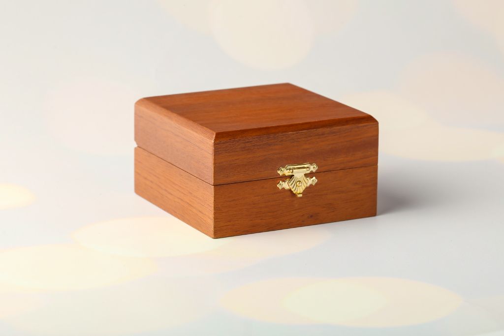 VIP wooden casket with gold clasp — closed view