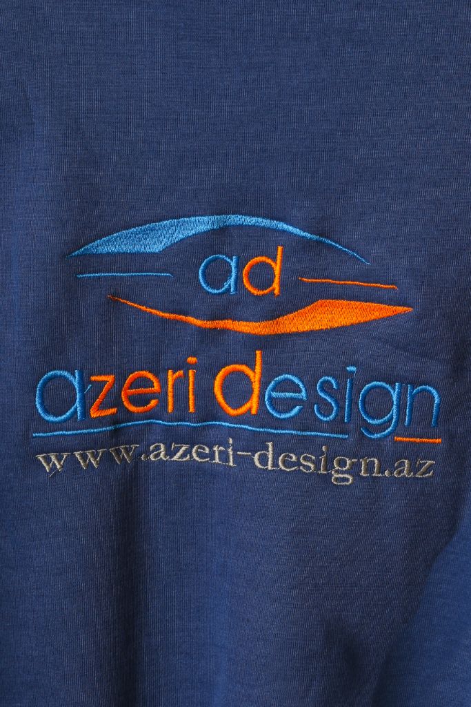 Azeri Design logo embroidery on sweatshirt back — close-up, navy blue, multicolour thread