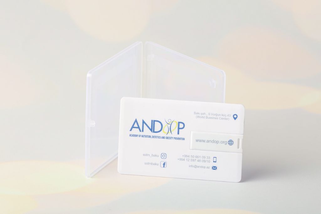 ANDOP Academy card-style USB flash drive — credit card format, logo + contacts, transparent plastic case, front view
