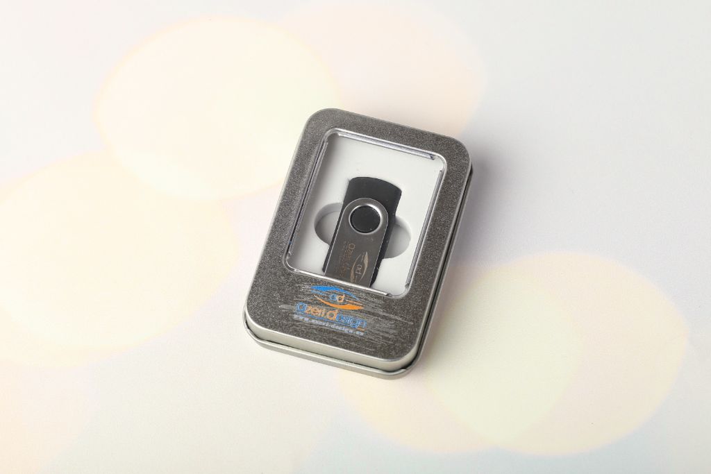 Owl Design tin box — lid with Owl Design logo, metal Swivel USB inside